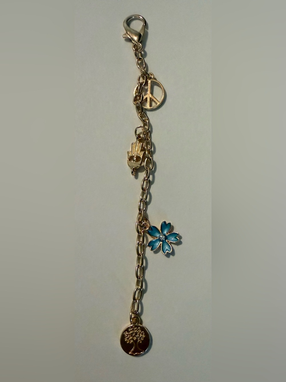 Gold-Tone Bracelet with Blue Flower Charm